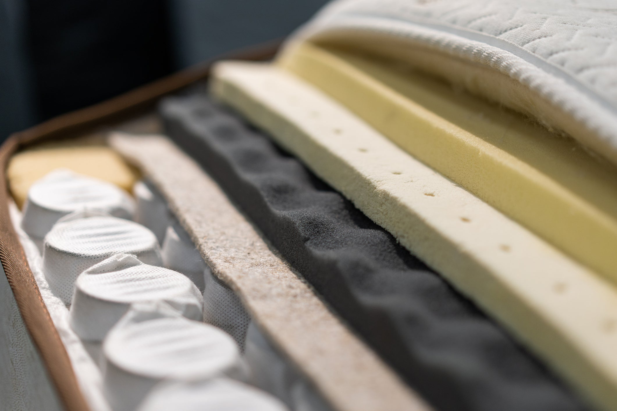 Mattress layers pulled apart showing quilting, foams, and pocket springs.