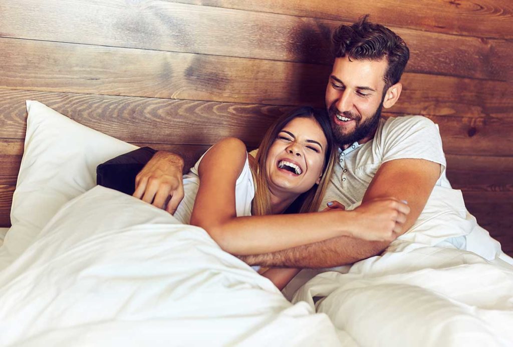A happy couple in bed