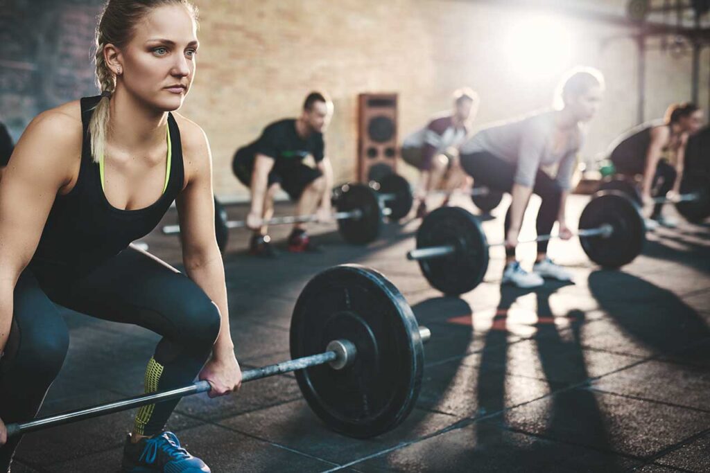 People in a gym lifting weights