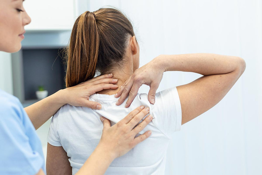 A young woman getting her spine adjusted by a back care professional