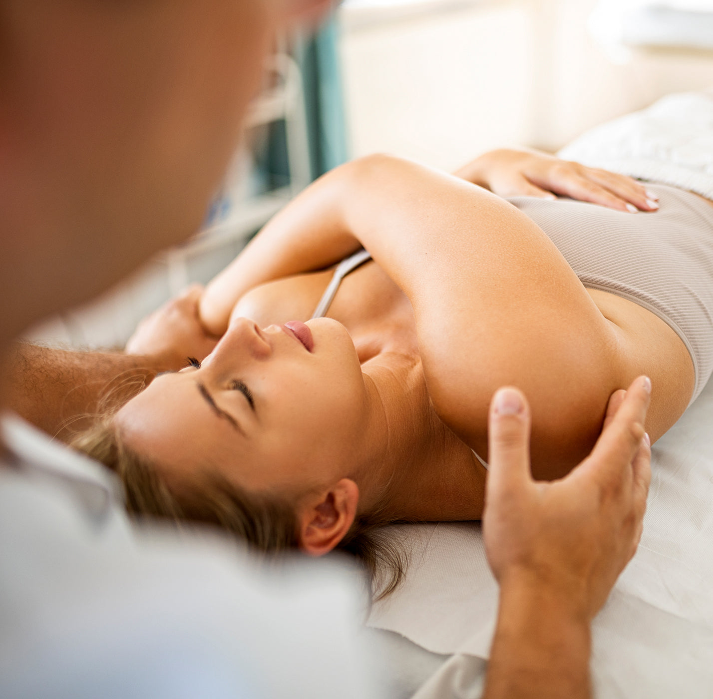 Woman receiving a massage from a professional in a clinical setting